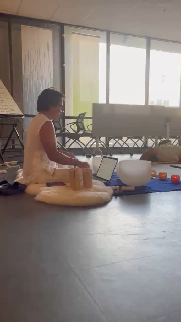 Nakhone Keodara preparing crystal singing bowls before a session