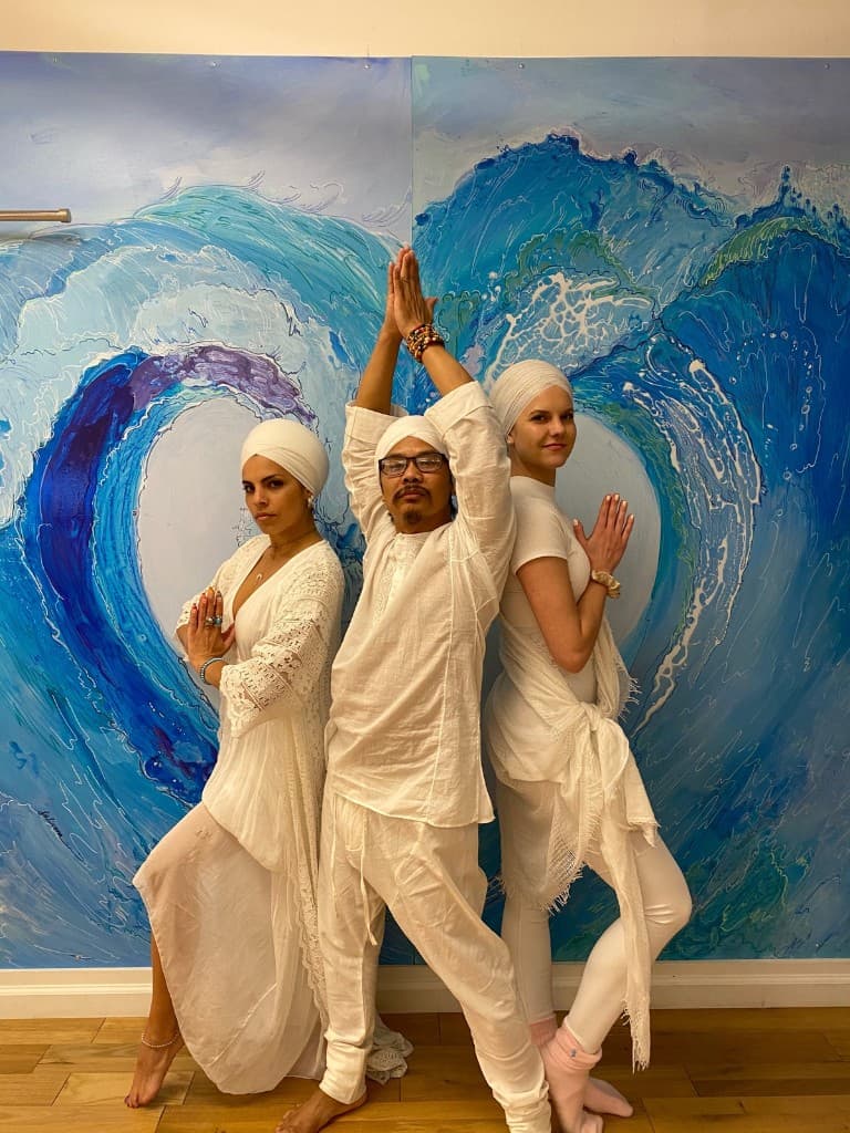 Nakhone Keodara with students in Kundalini Yoga prayer pose