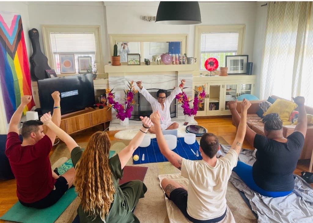 Nakhone Keodara leading a Kundalini Yoga class with students