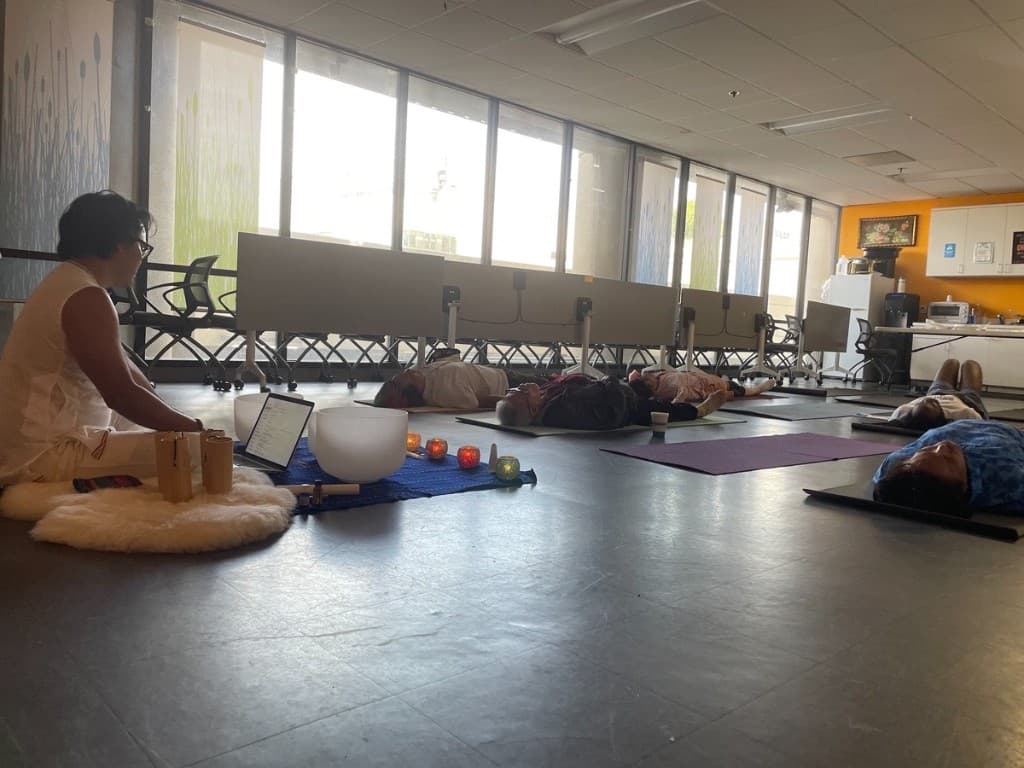 Nakhone Keodara facilitating a group sound bath at APAIT Health Center