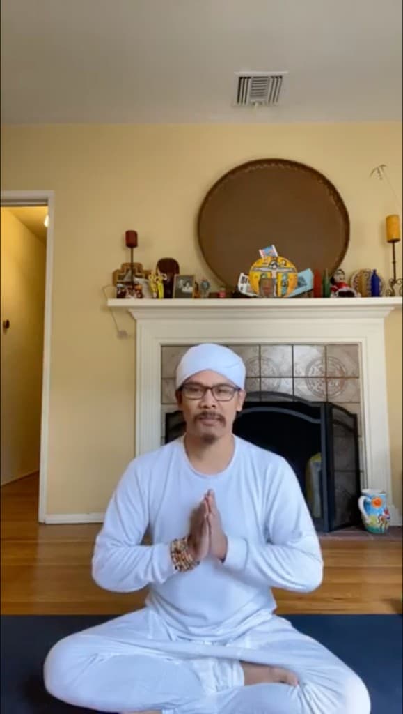 Nakhone Keodara greeting a student with prayer hands